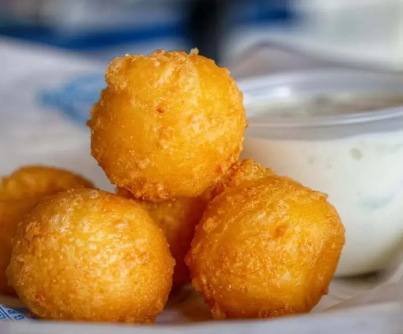 Fried cheese balls with a dish of tzatziki