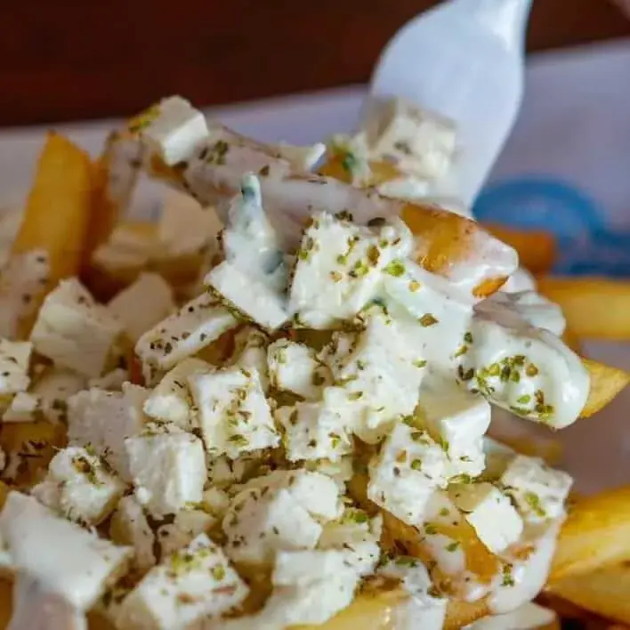 Fries topped with crumbled feta and oregano