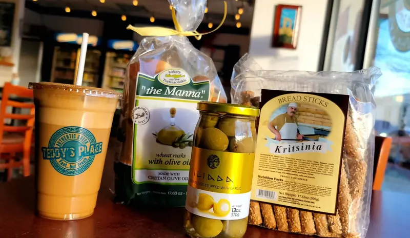 Greek market shelf: jarred olives, olive oil and imported biscuits